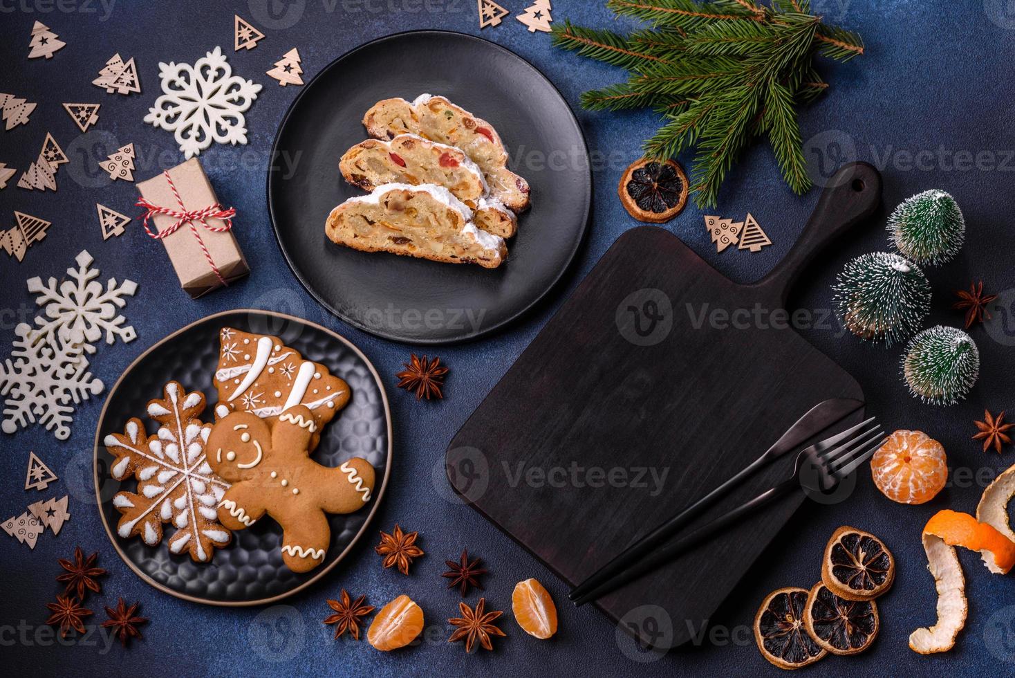 Delicious festive New Year's pie with candied fruits, marzipan and nuts on a dark concrete background photo