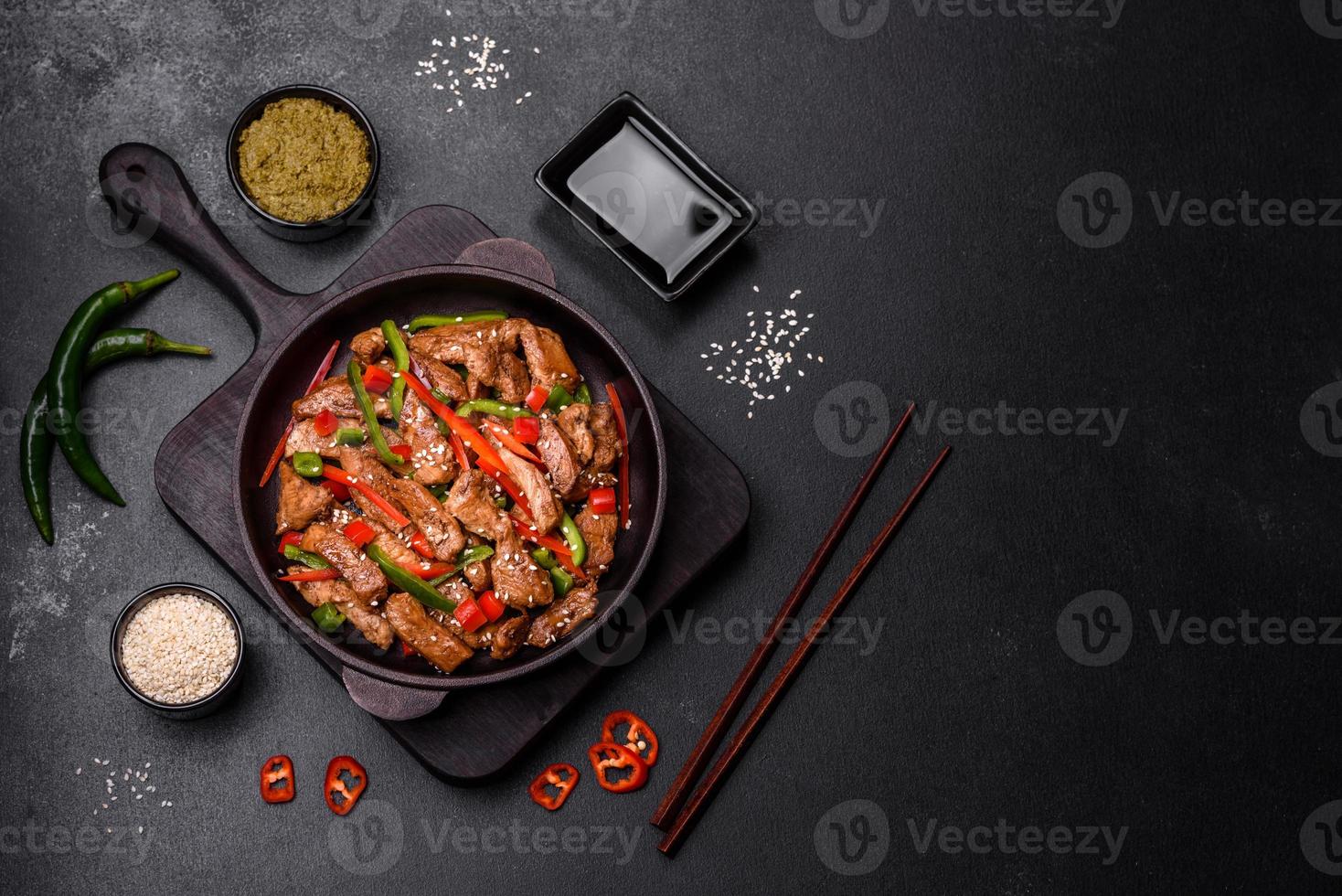Delicious Asian teriyaki meat with red and green bell peppers photo