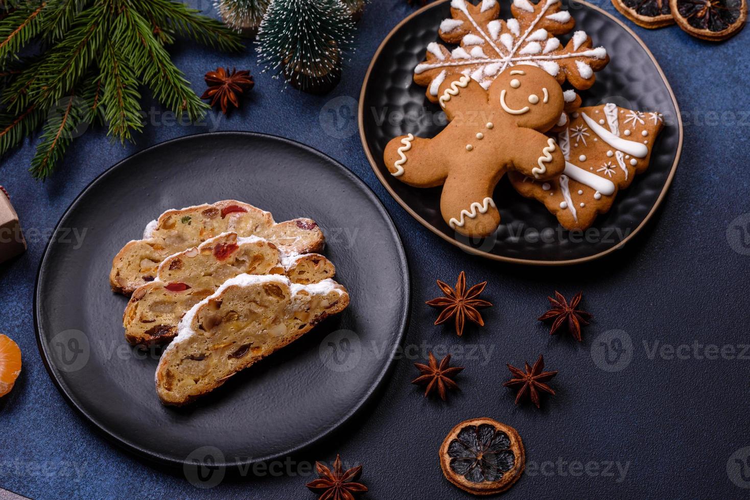 Delicious festive New Year's pie with candied fruits, marzipan and nuts on a dark concrete background photo