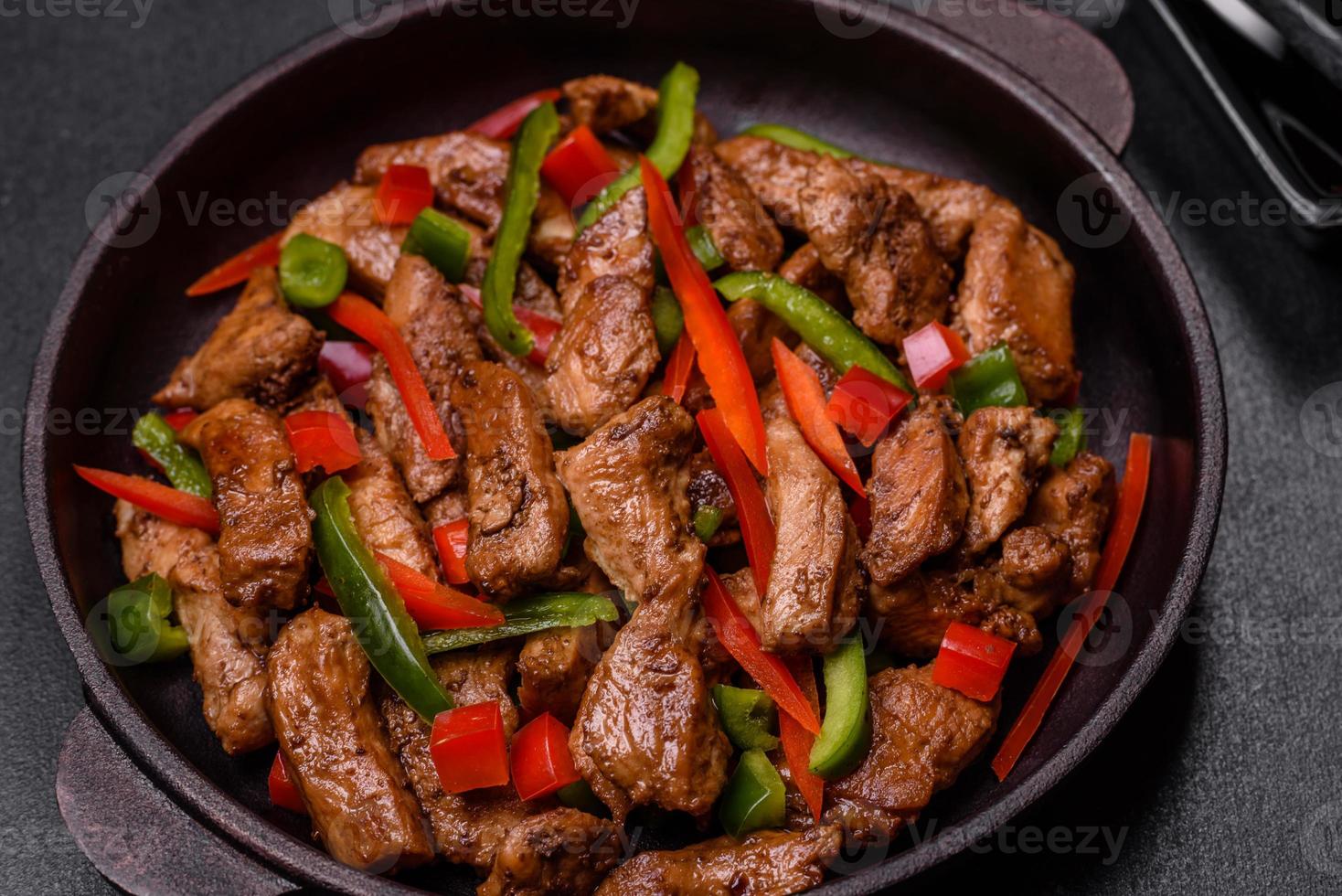 Delicious Asian teriyaki meat with red and green bell peppers photo