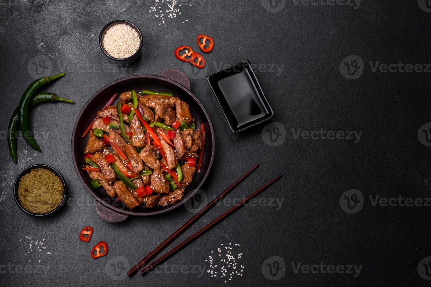 Delicious Asian teriyaki meat with red and green bell peppers photo