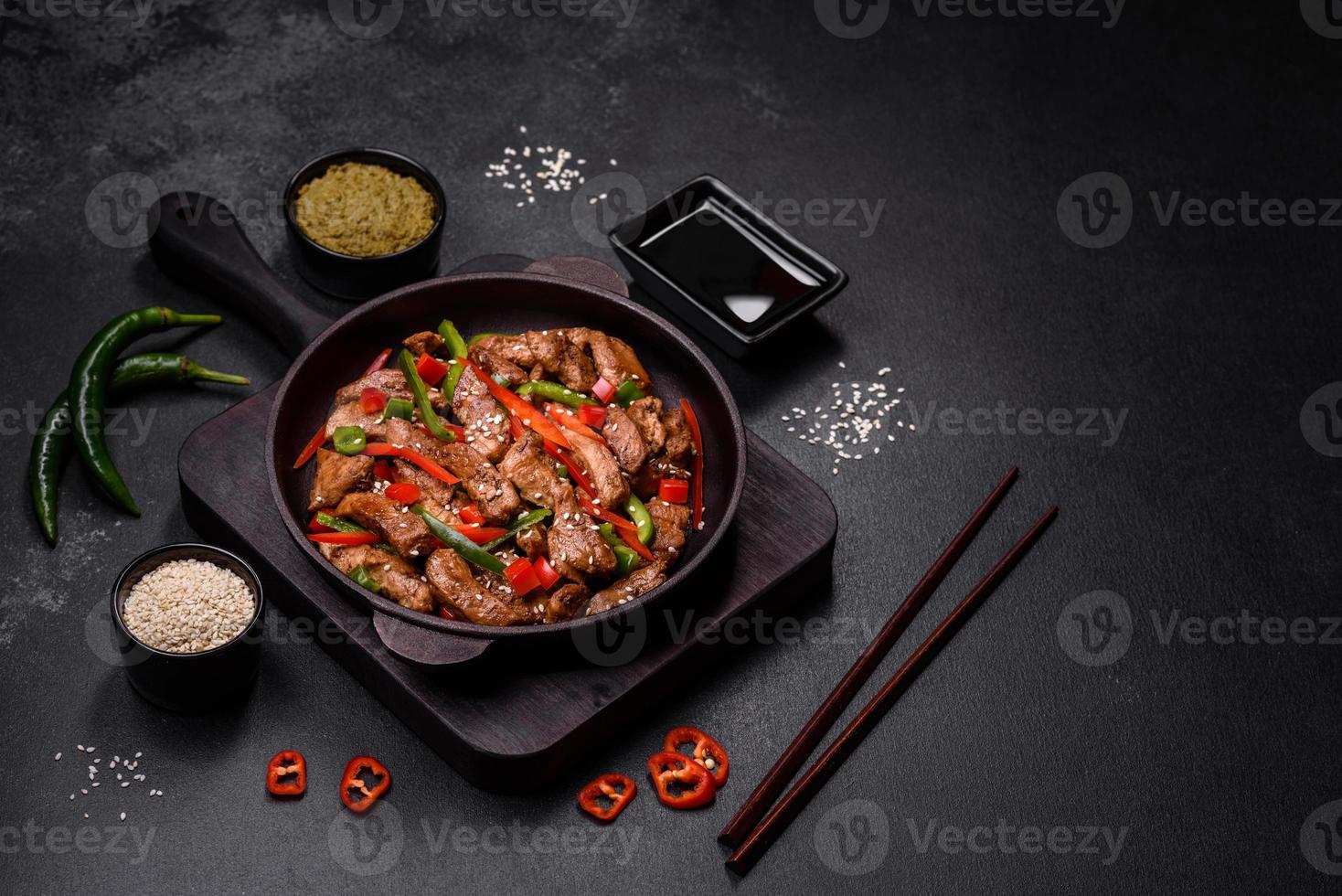Delicious Asian teriyaki meat with red and green bell peppers photo