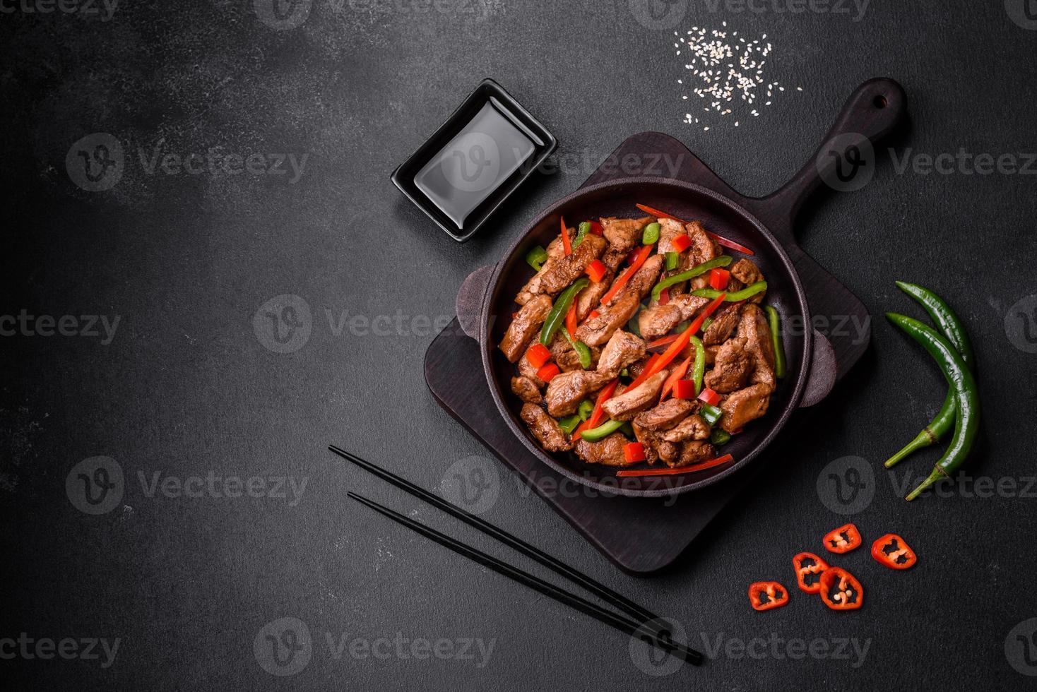 Delicious Asian teriyaki meat with red and green bell peppers photo