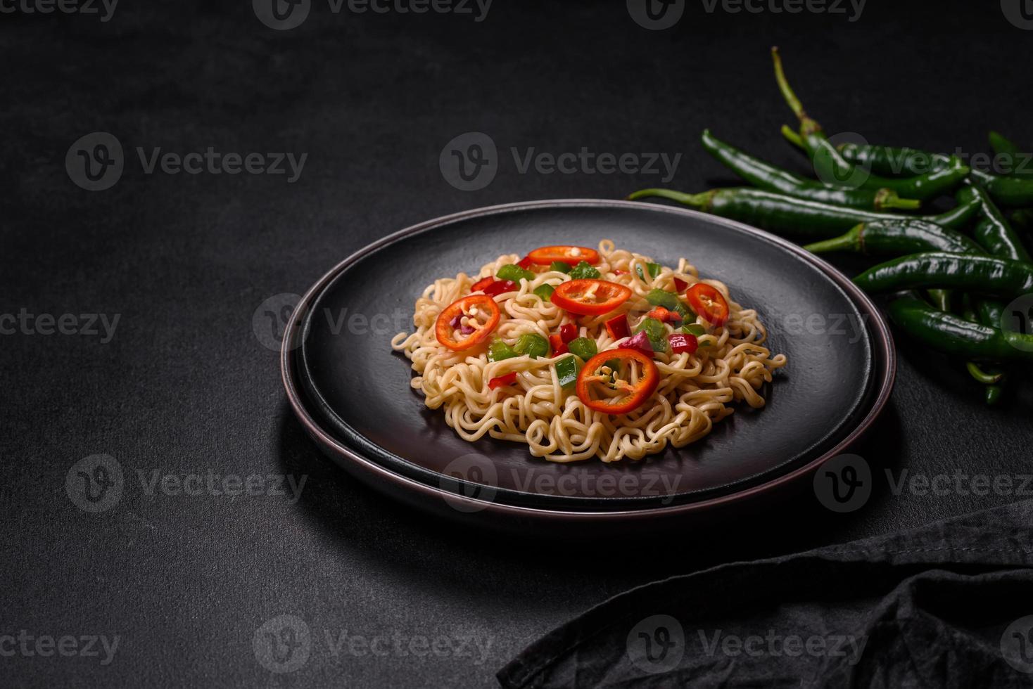 Delicious fresh noodles with sweet pepper, tomato, spices and herbs photo