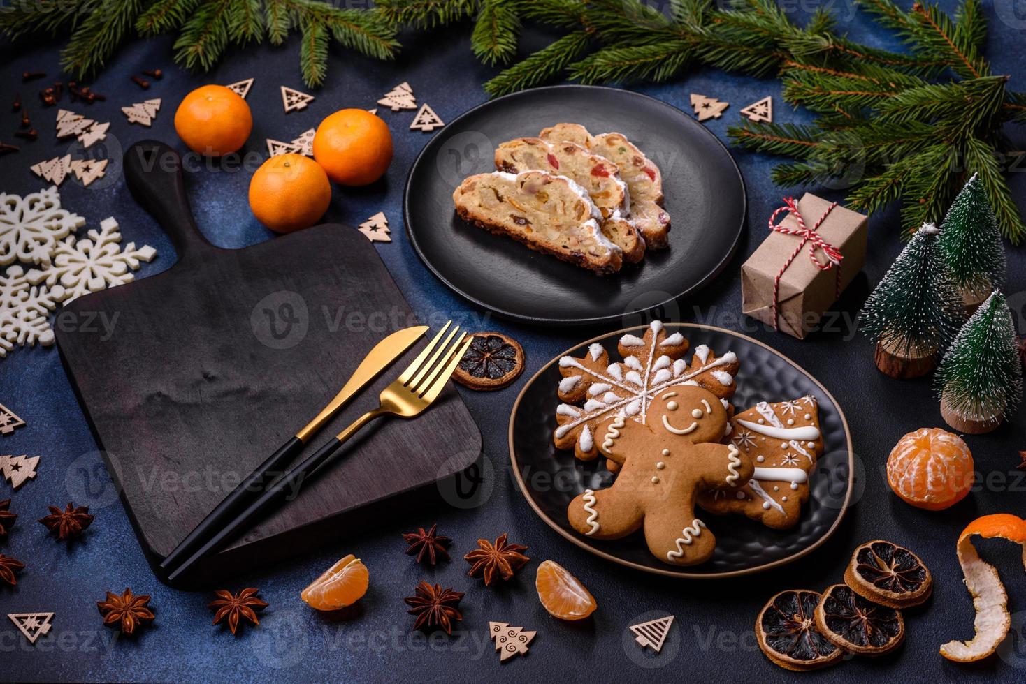 Delicious festive New Year's pie with candied fruits, marzipan and nuts on a dark concrete background photo