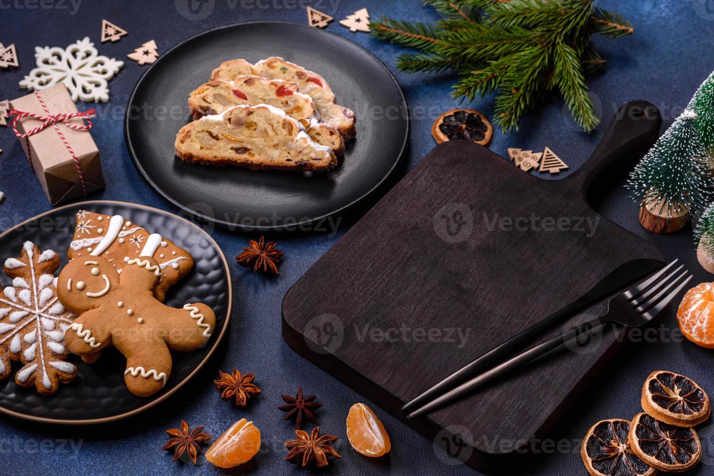 Delicious festive New Year's pie with candied fruits, marzipan and nuts on a dark concrete background photo