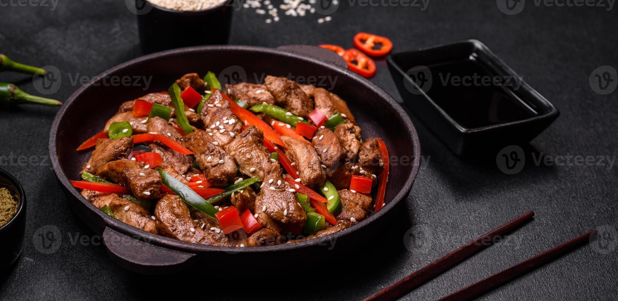 Delicious Asian teriyaki meat with red and green bell peppers photo
