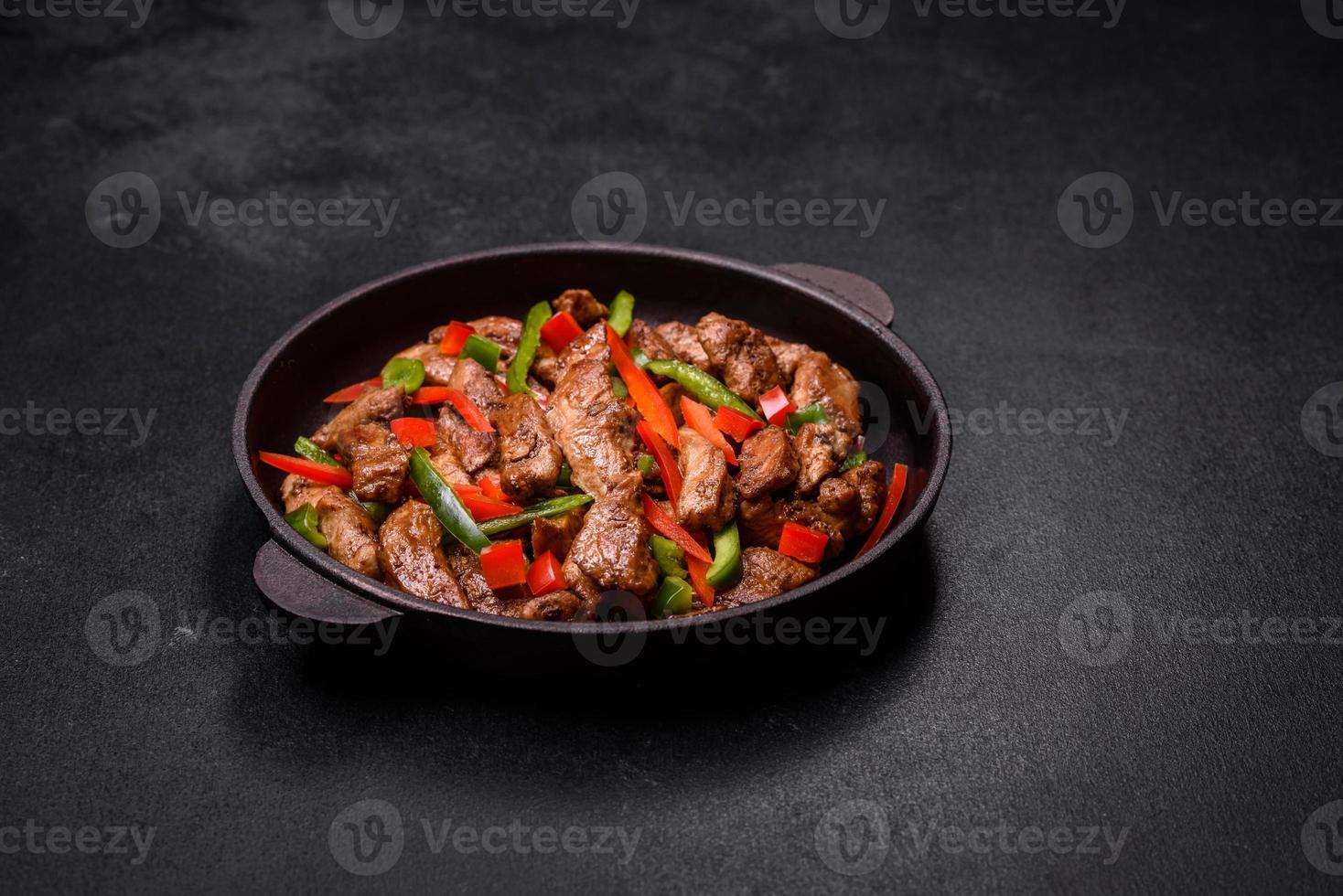 Delicious Asian teriyaki meat with red and green bell peppers photo