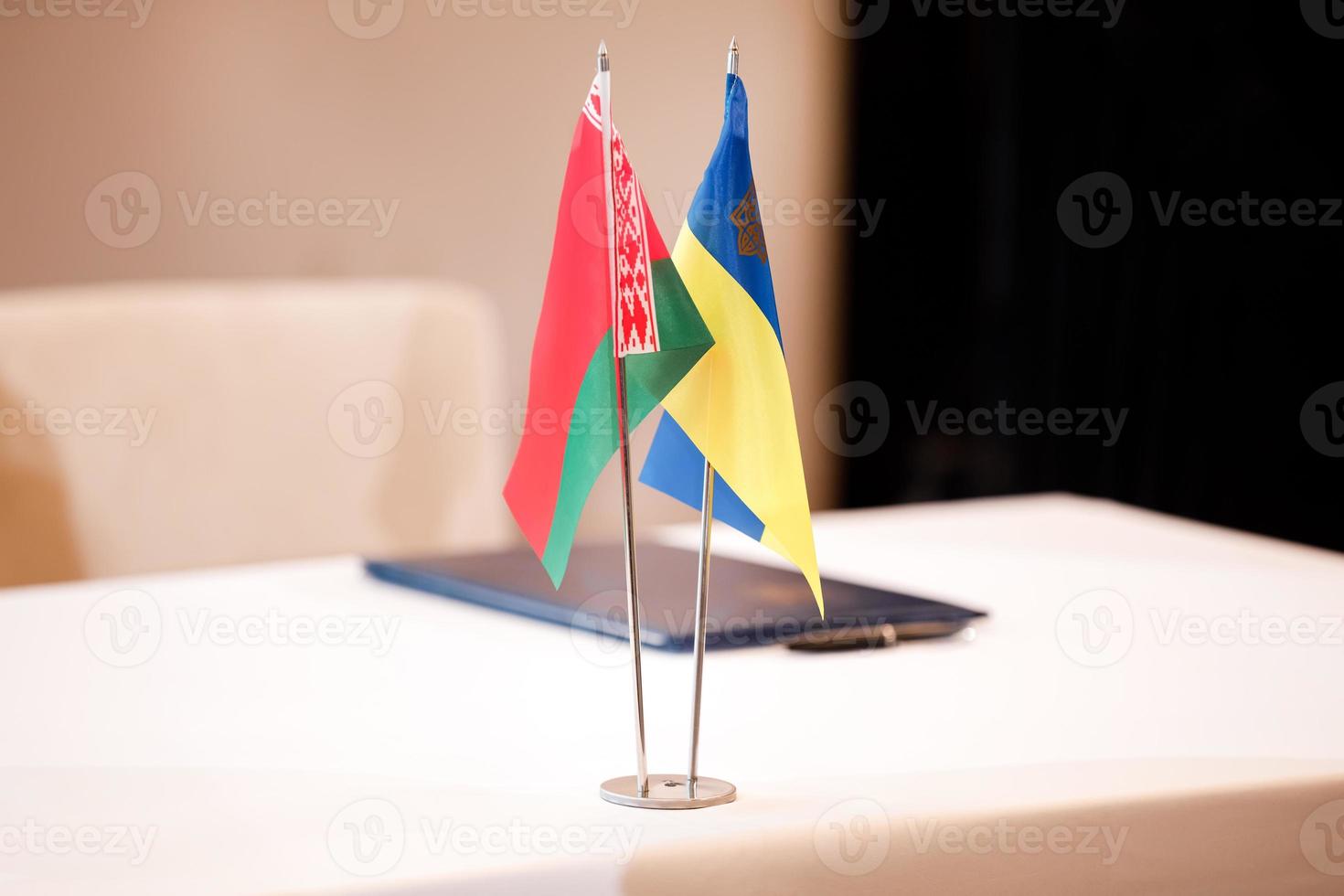 red green national flag of Belarus and blue yellow flag of Ukraine. Minsk ceasefire talks between Ukraine and Russia. Symbol of Belarusian-Ukrainian friendship. photo