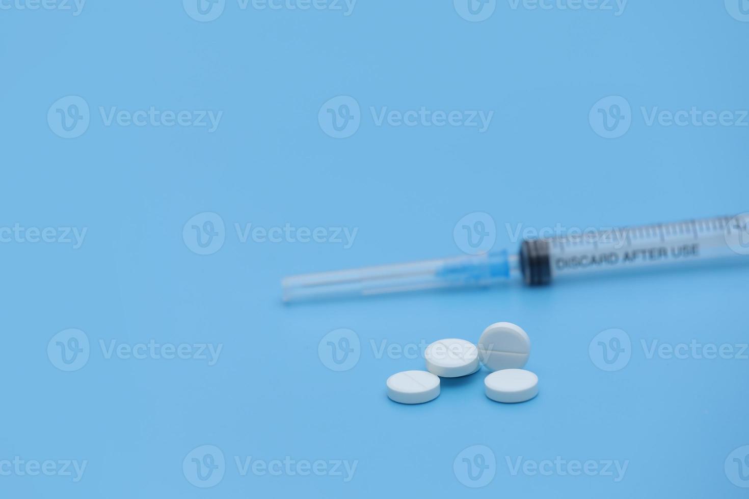 A bunch of pills and tablets on a blue background. Isolated. Copy space. Macro of white capsules on rwhite background. cold flu treatment. photo