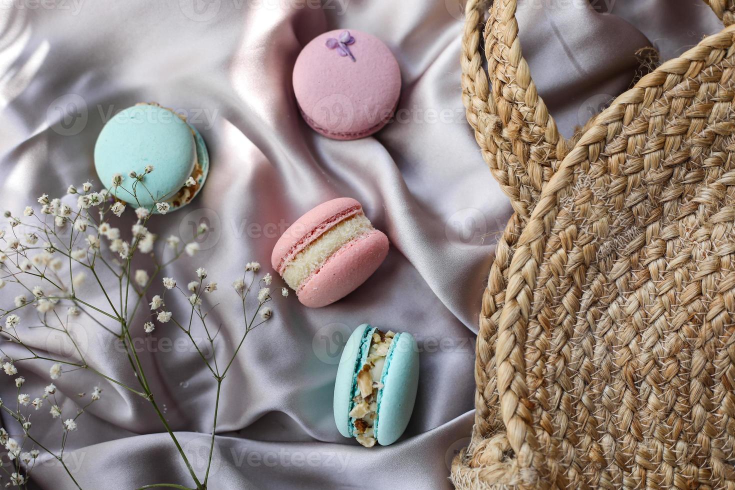 pink and mint french macaroons or macarons cookies and a white flowers on a cloth background. Natural fruit and berry flavors, creamy stuffing for valentines mother day easter with love food photo