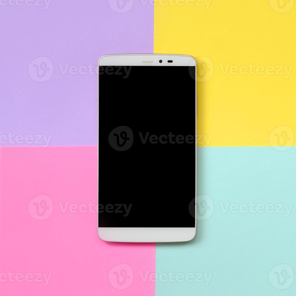 Modern smartphone with black screen on texture background of fashion pastel blue, yellow, violet and pink colors paper in minimal concept photo