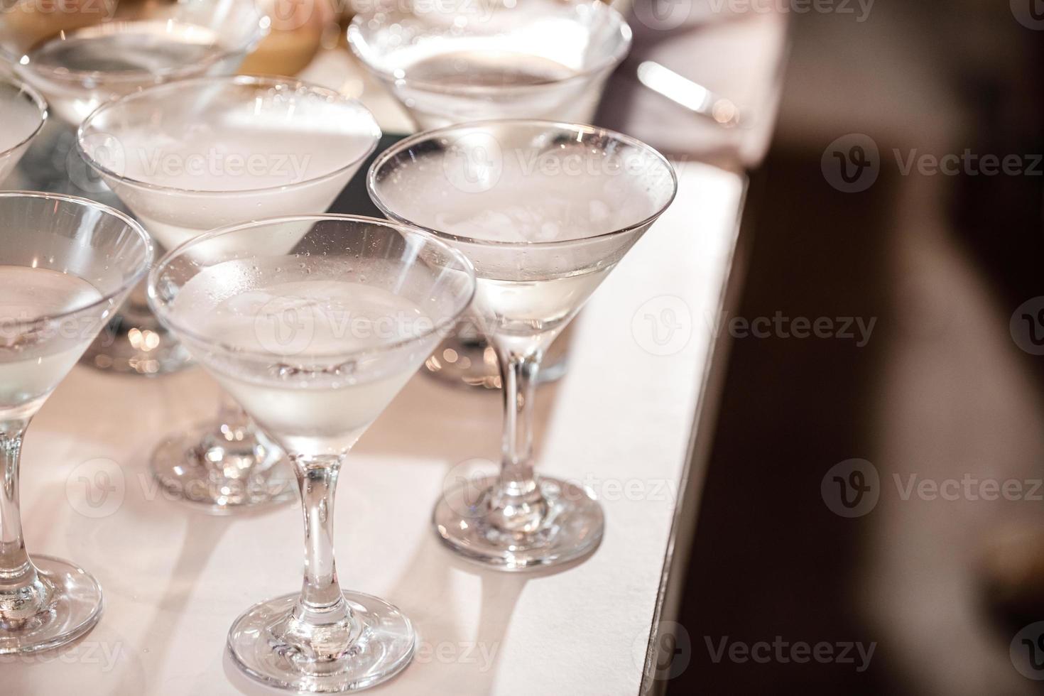 alcoholic beverage in martini glasses with dry ice photo