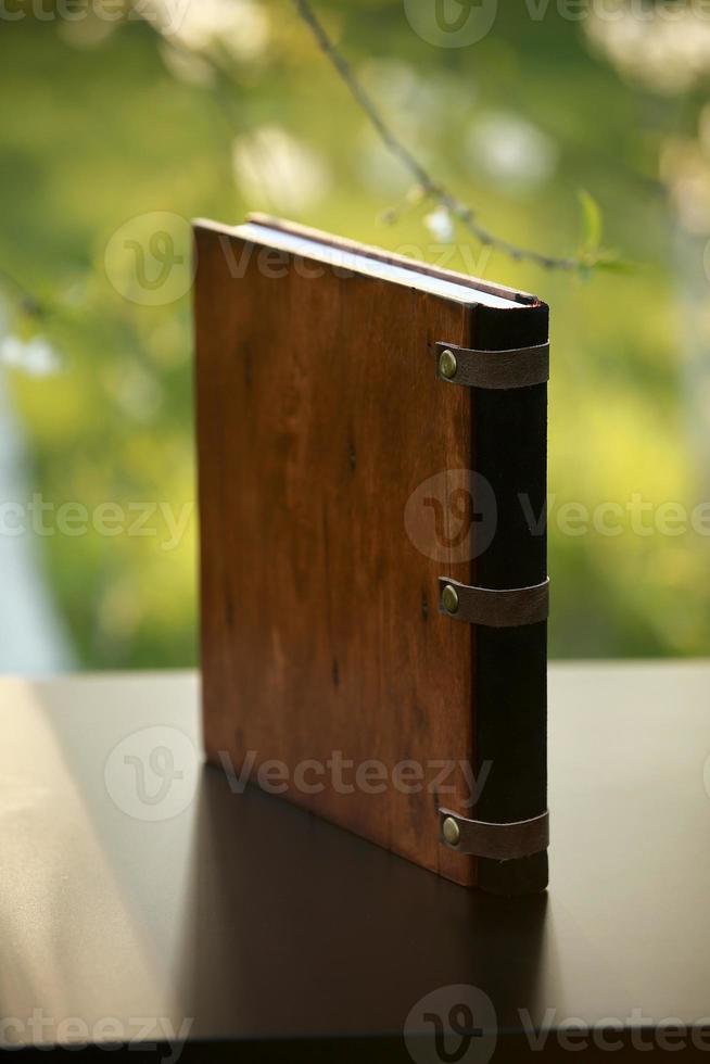 fotolibro de madera sobre la mesa. vista lateral foto