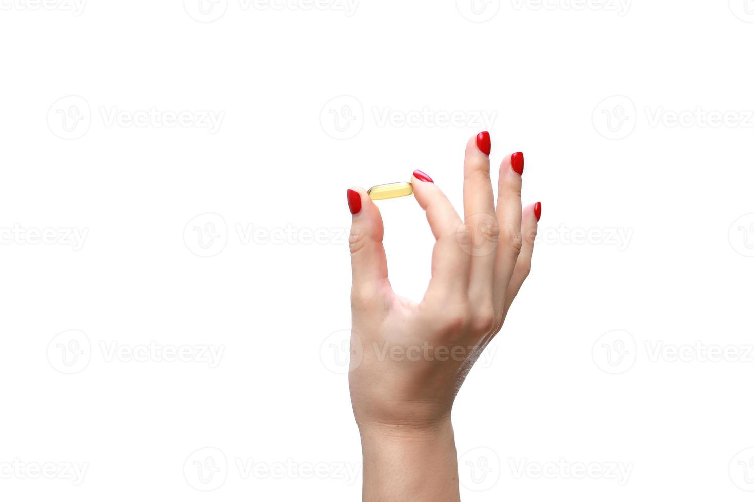Hand holding capsule of Omega 3 on white background. Close up. High resolution product. Health care concept photo