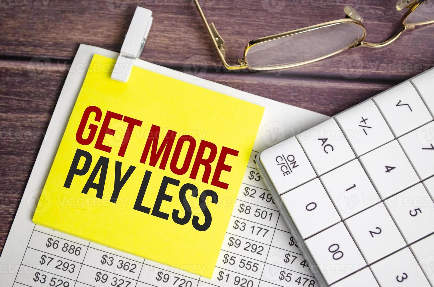 get more pay less Text on business paper on office table photo