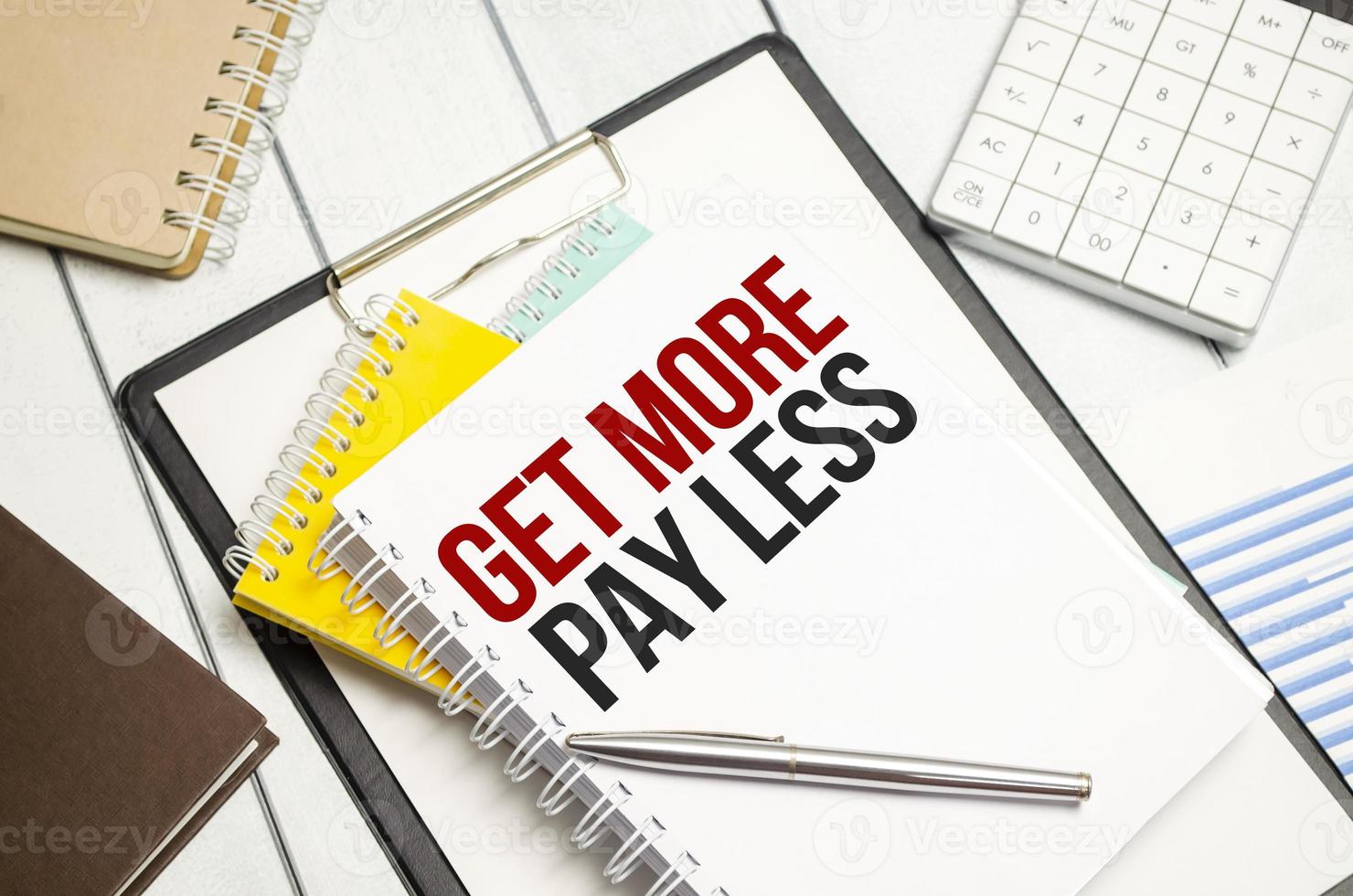 get more pay less . Conceptual background with chart ,papers and pen photo