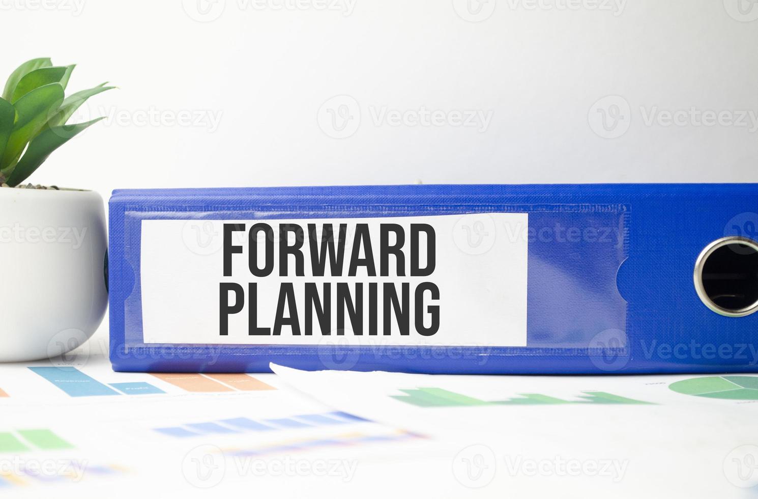 paper folder with forward planning words and charts photo