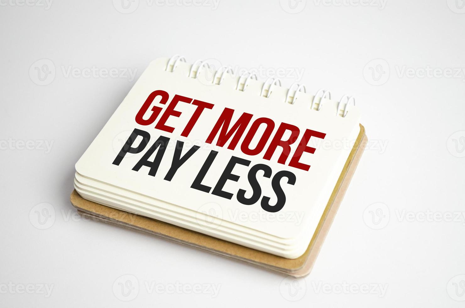 get more pay less Text on business paper on office table photo