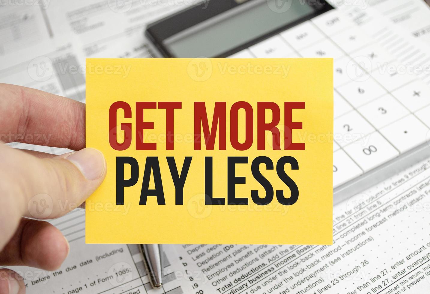 get more pay less. Text on yellow sticker with calculator photo