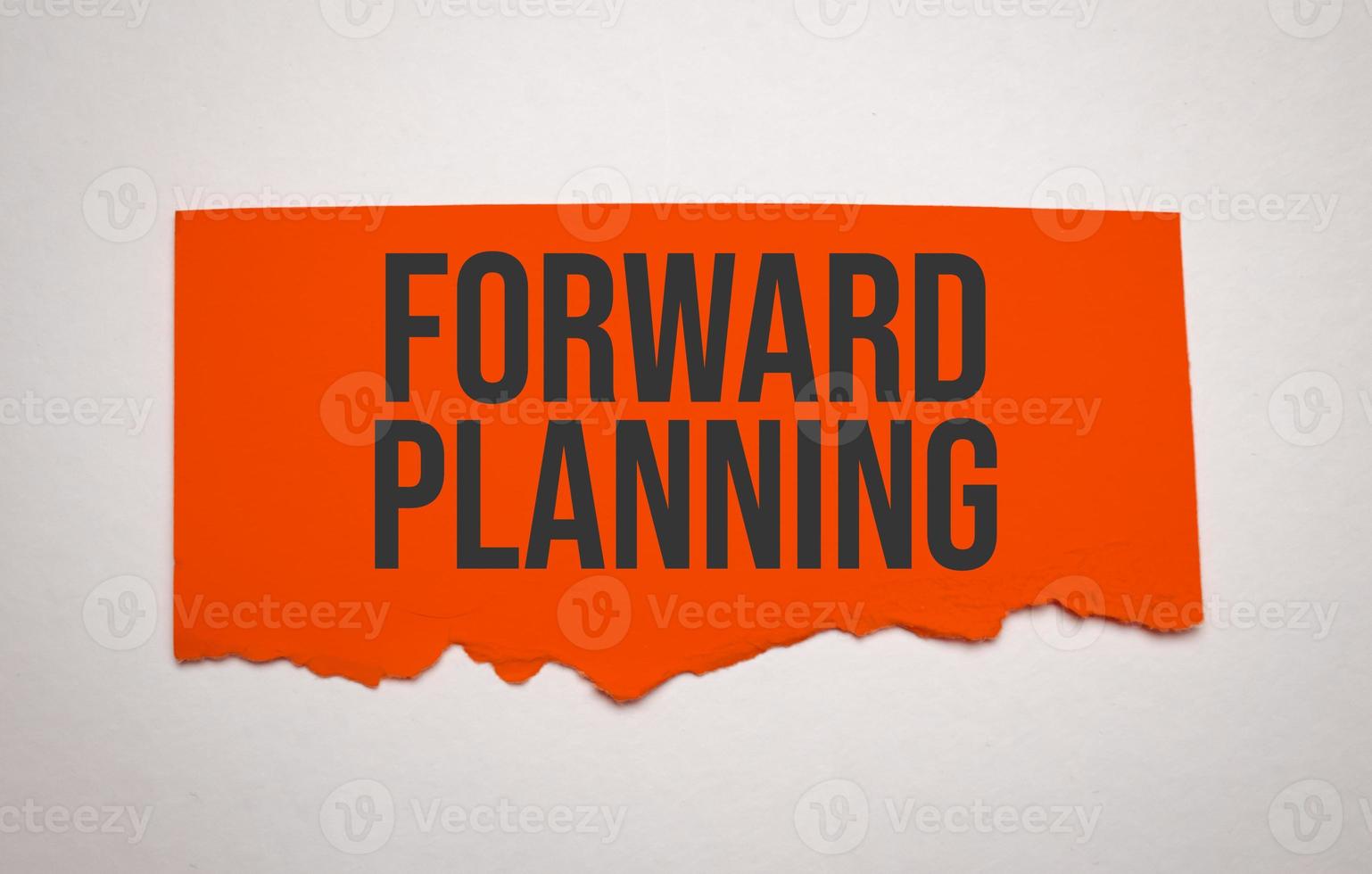 red torn paper with forward planning words photo