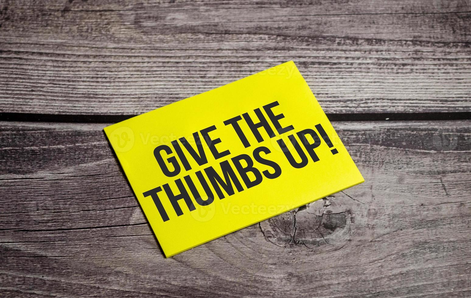 give the thumbs up Text on business paper on office table photo