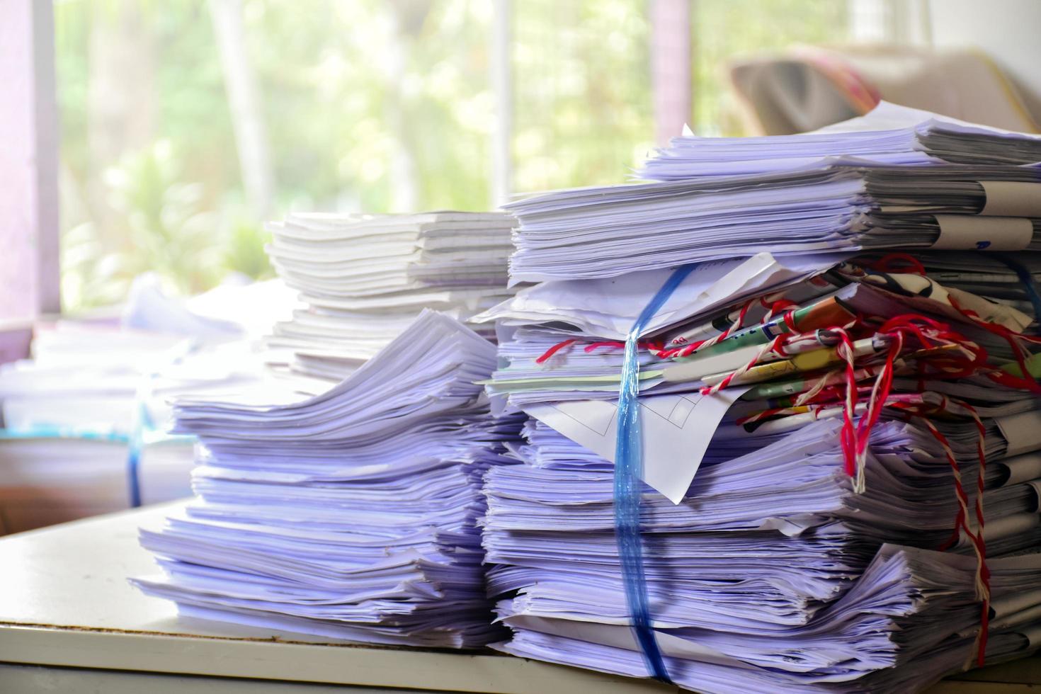 Used paper of various sizes is bundled together to sell or make recycled paper on the front porch of an office, soft focus, sunlight edited, environmental frineds concept. photo