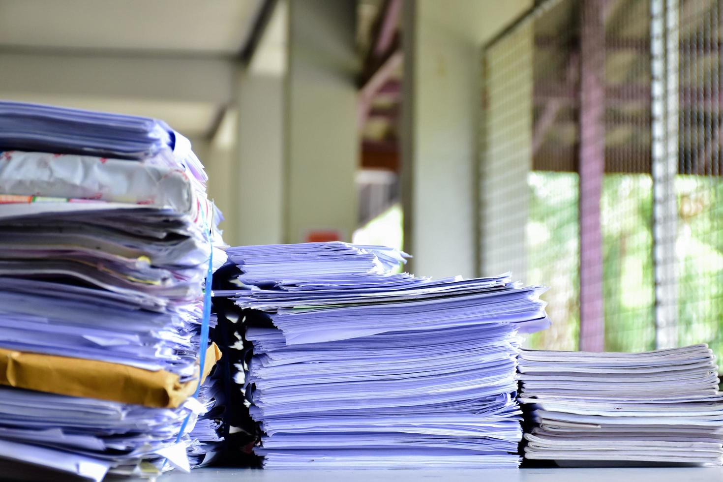 Used paper of various sizes is bundled together to sell or make recycled paper on the front porch of an office, soft focus, sunlight edited, environmental frineds concept. photo