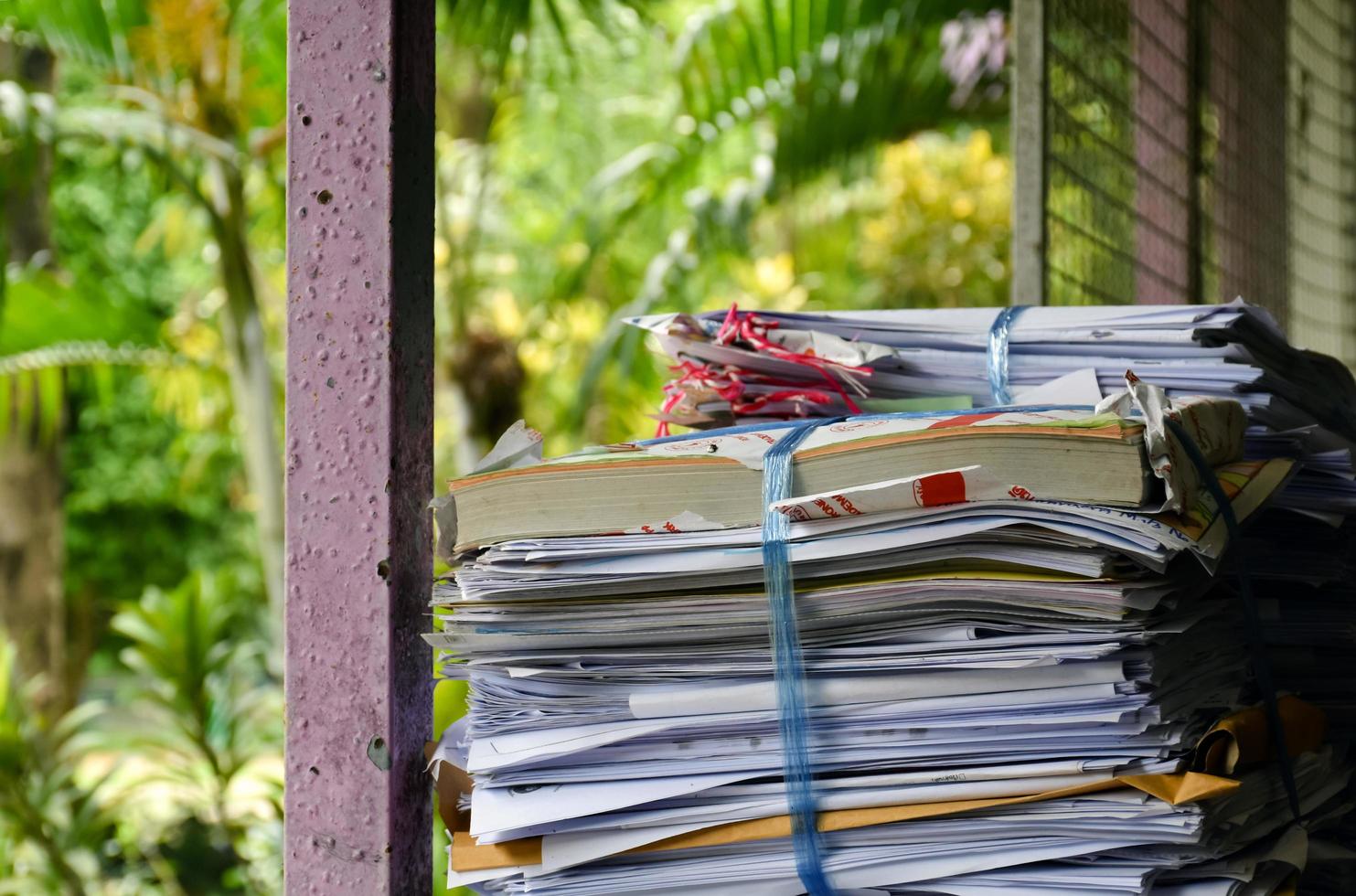 Used paper of various sizes is bundled together to sell or make recycled paper on the front porch of an office, soft focus, sunlight edited, environmental frineds concept. photo