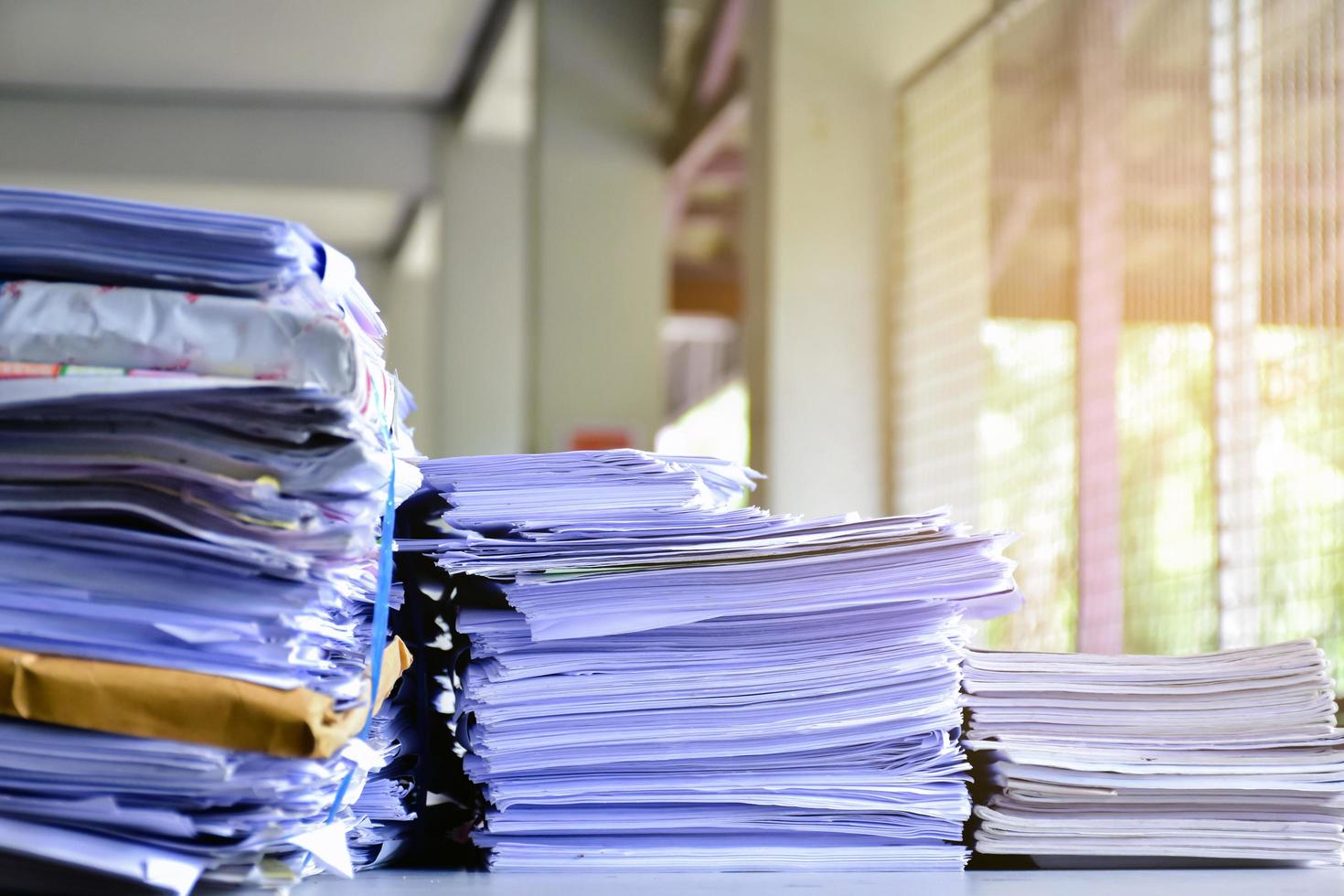 Used paper of various sizes is bundled together to sell or make recycled paper on the front porch of an office, soft focus, sunlight edited, environmental frineds concept. photo