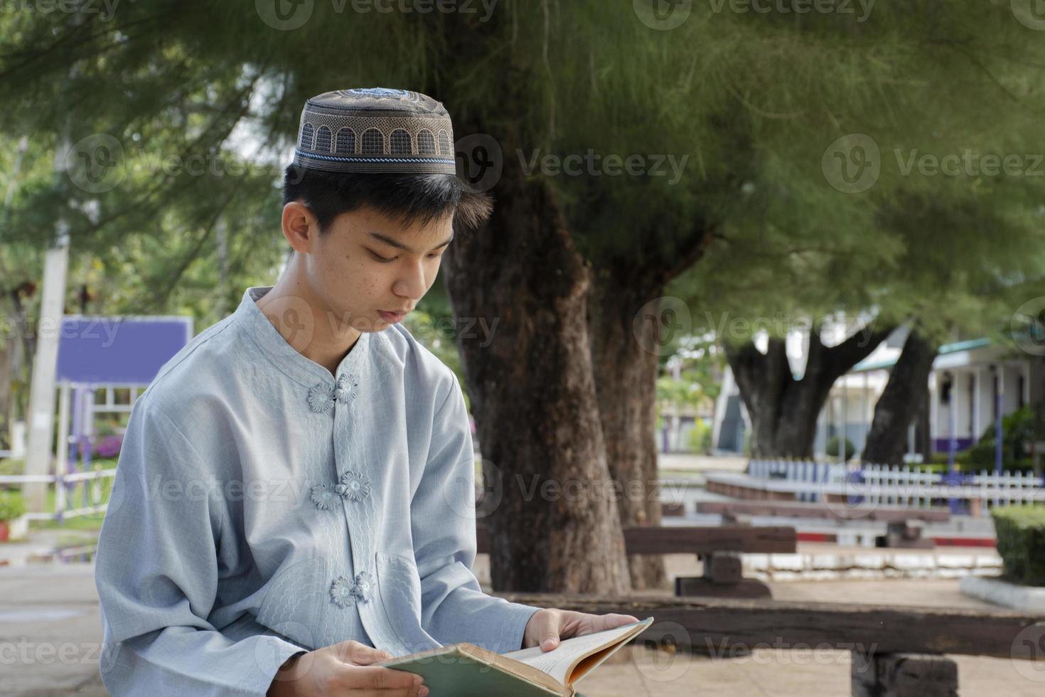 Portrait young southeast asian islamic or muslim boy in white shirt and hat, isolated on white, soft and selective focus. photo