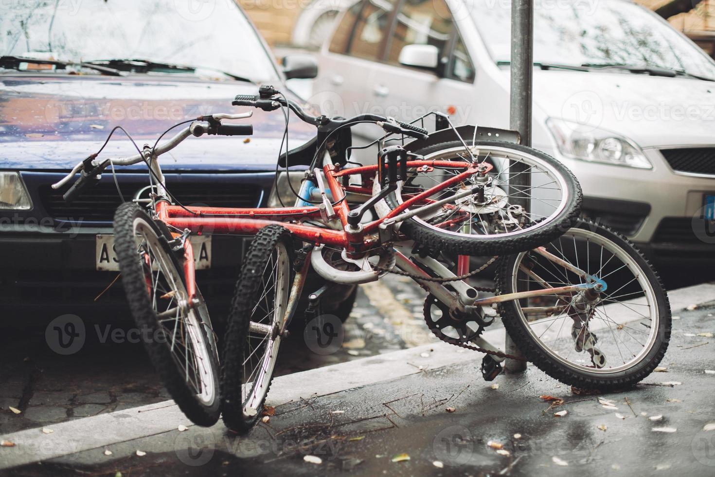 abandoned old rusty bicycles on city streets. photo