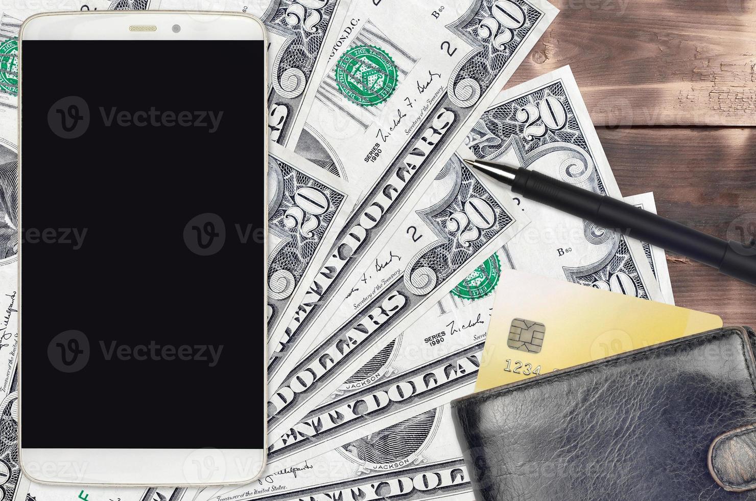 20 US dollars bills and smartphone with purse and credit card. E-payments or e-commerce concept. Online shopping and business with portable devices photo