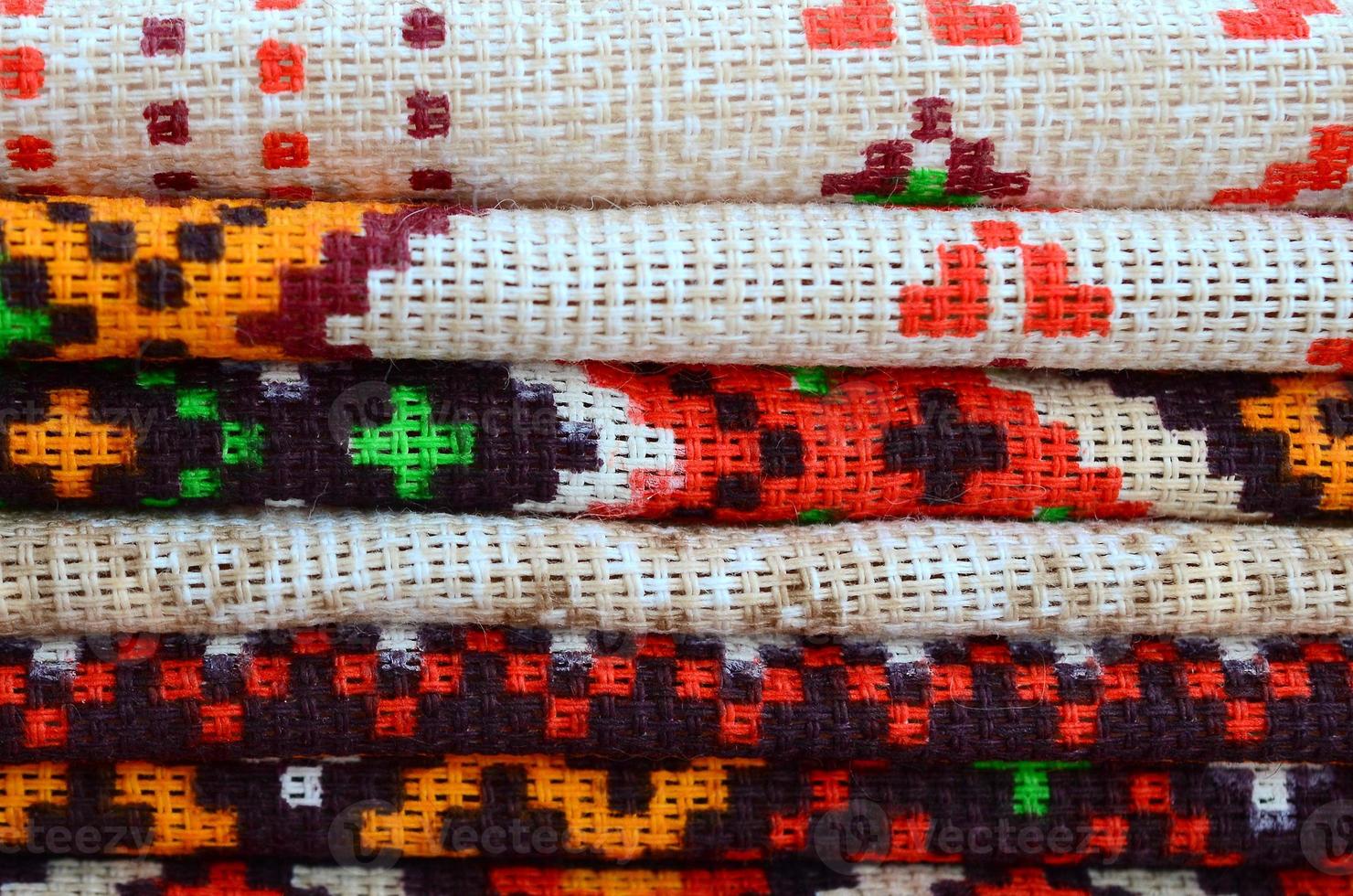Stack of traditional Ukrainian folk art knitted embroidery patterns on textile fabric photo