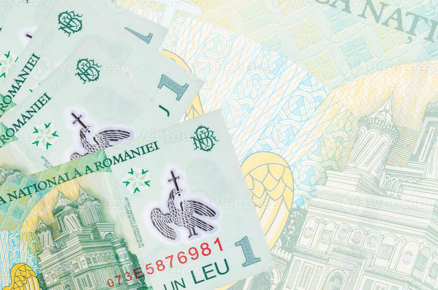 1 Romanian leu bills lies in stack on background of big semi-transparent banknote. Abstract business background photo