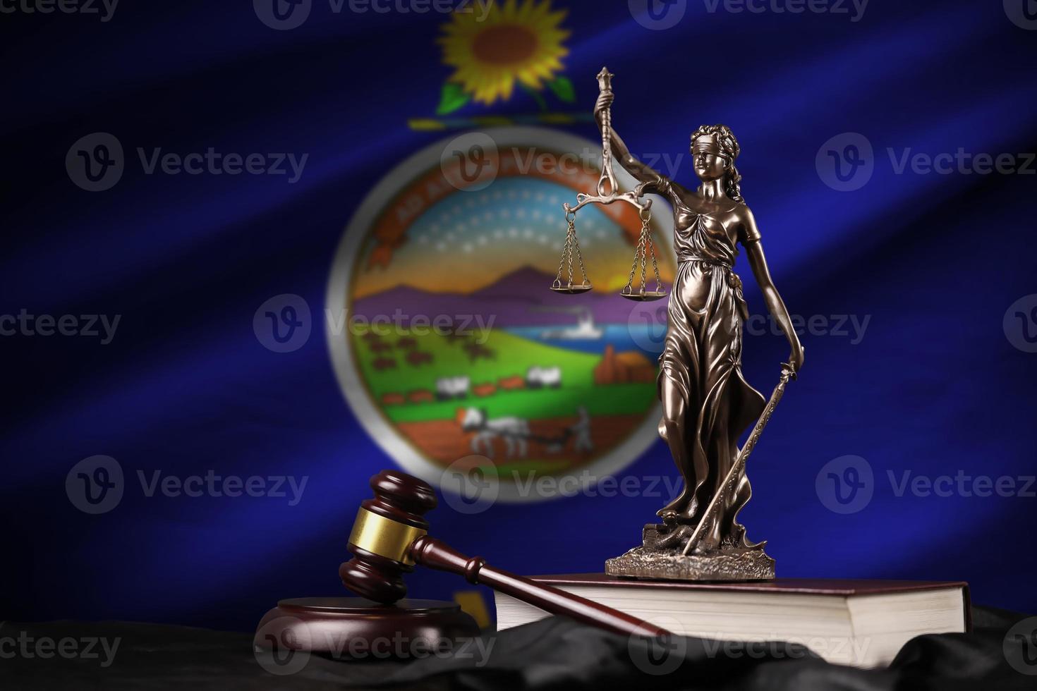 Kansas US state flag with statue of lady justice, constitution and judge hammer on black drapery. Concept of judgement and guilt photo