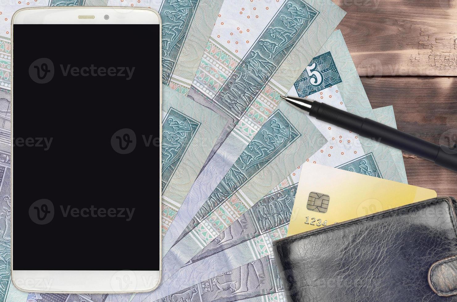 5 Egyptian pounds bills and smartphone with purse and credit card. E-payments or e-commerce concept. Online shopping and business with portable devices photo