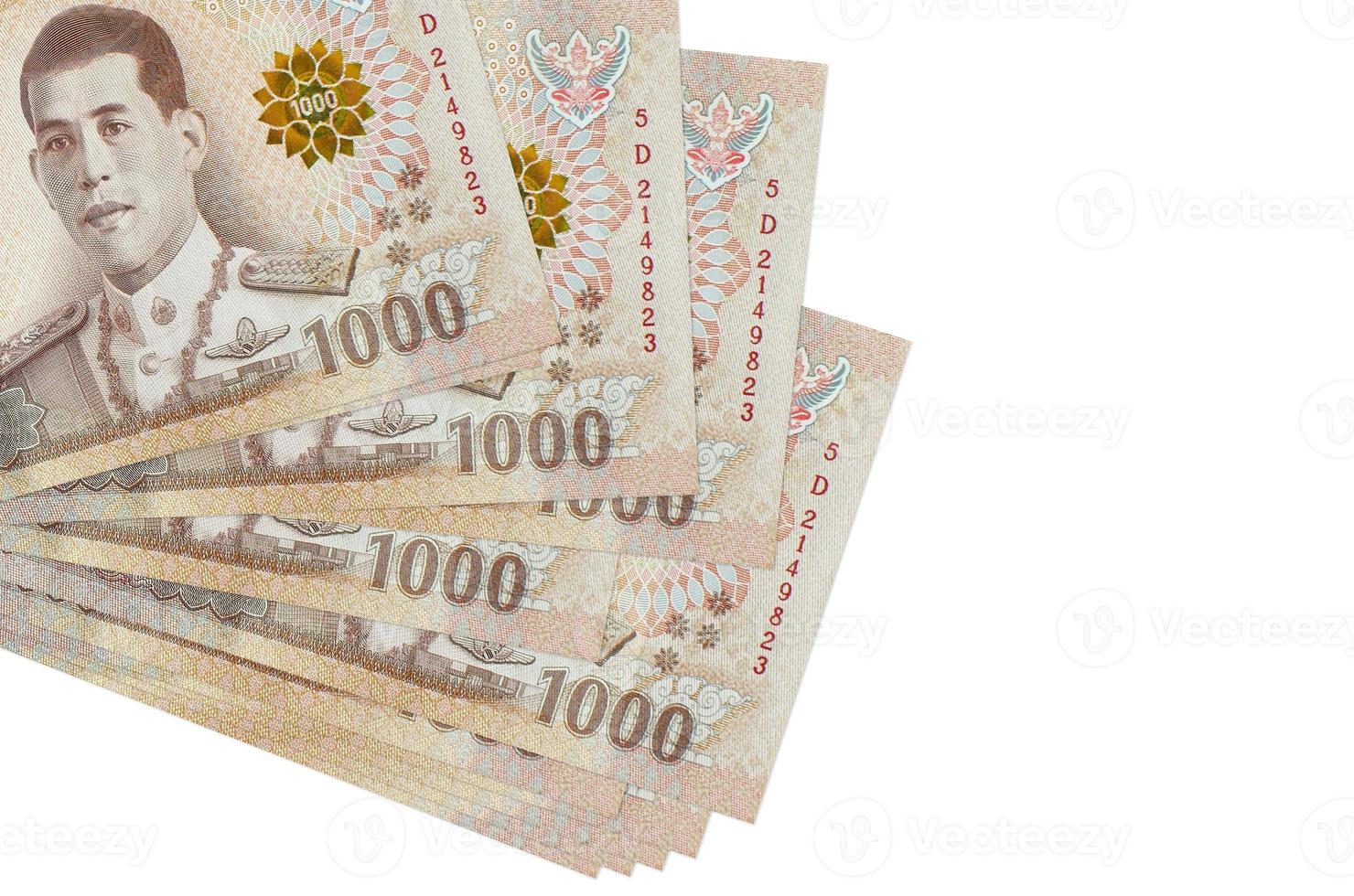 1000 Thai baht bills lies in small bunch or pack isolated on white. Mockup with copy space. Business and currency exchange photo