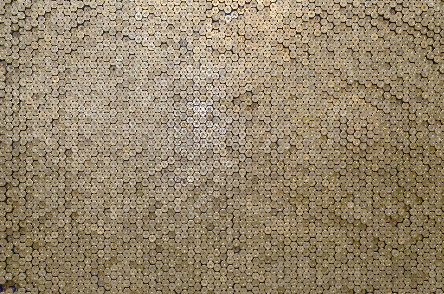 Pattern of 12 gauge cartridges for shotgun bullets. Shells for hunting rifle close up. Backdrop for shooting range or ammunition trade concepts photo