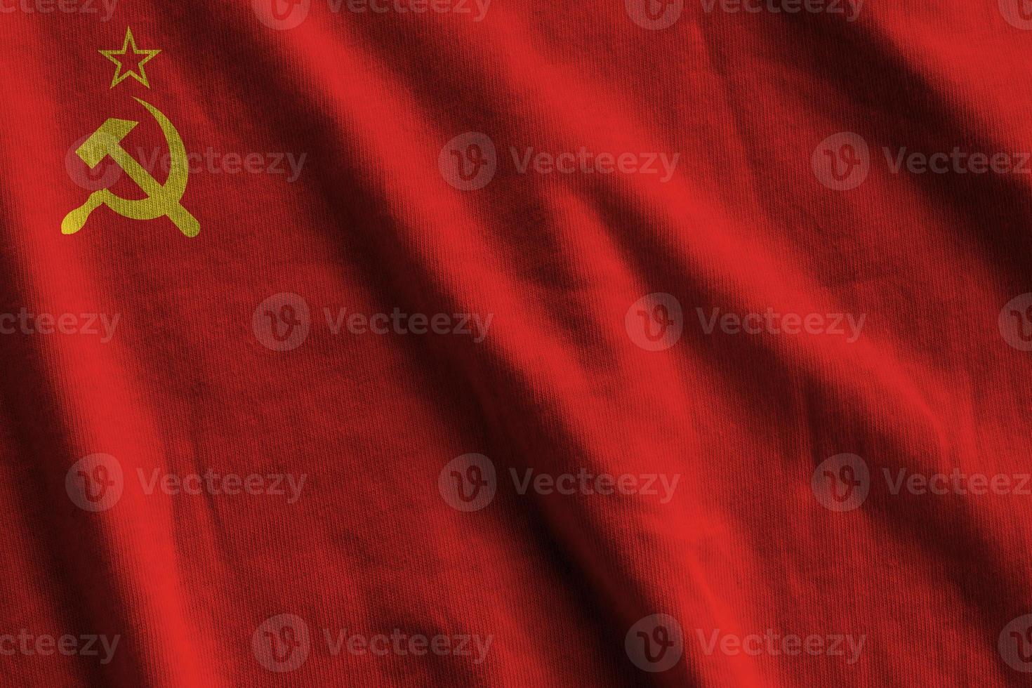 Soviet Union flag with big folds waving close up under the studio light indoors. The official symbols and colors in banner photo