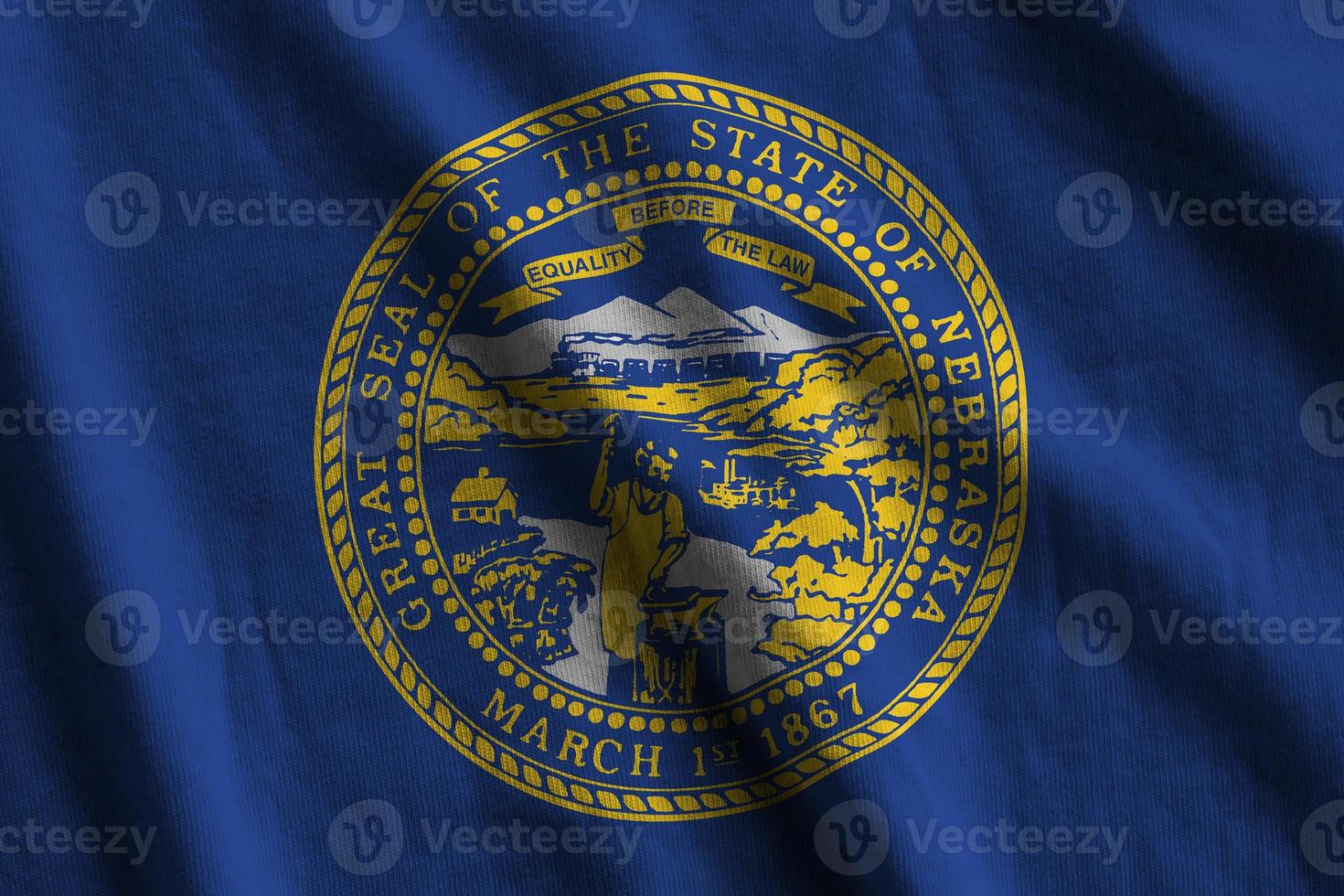 Nebraska US state flag with big folds waving close up under the studio light indoors. The official symbols and colors in banner photo