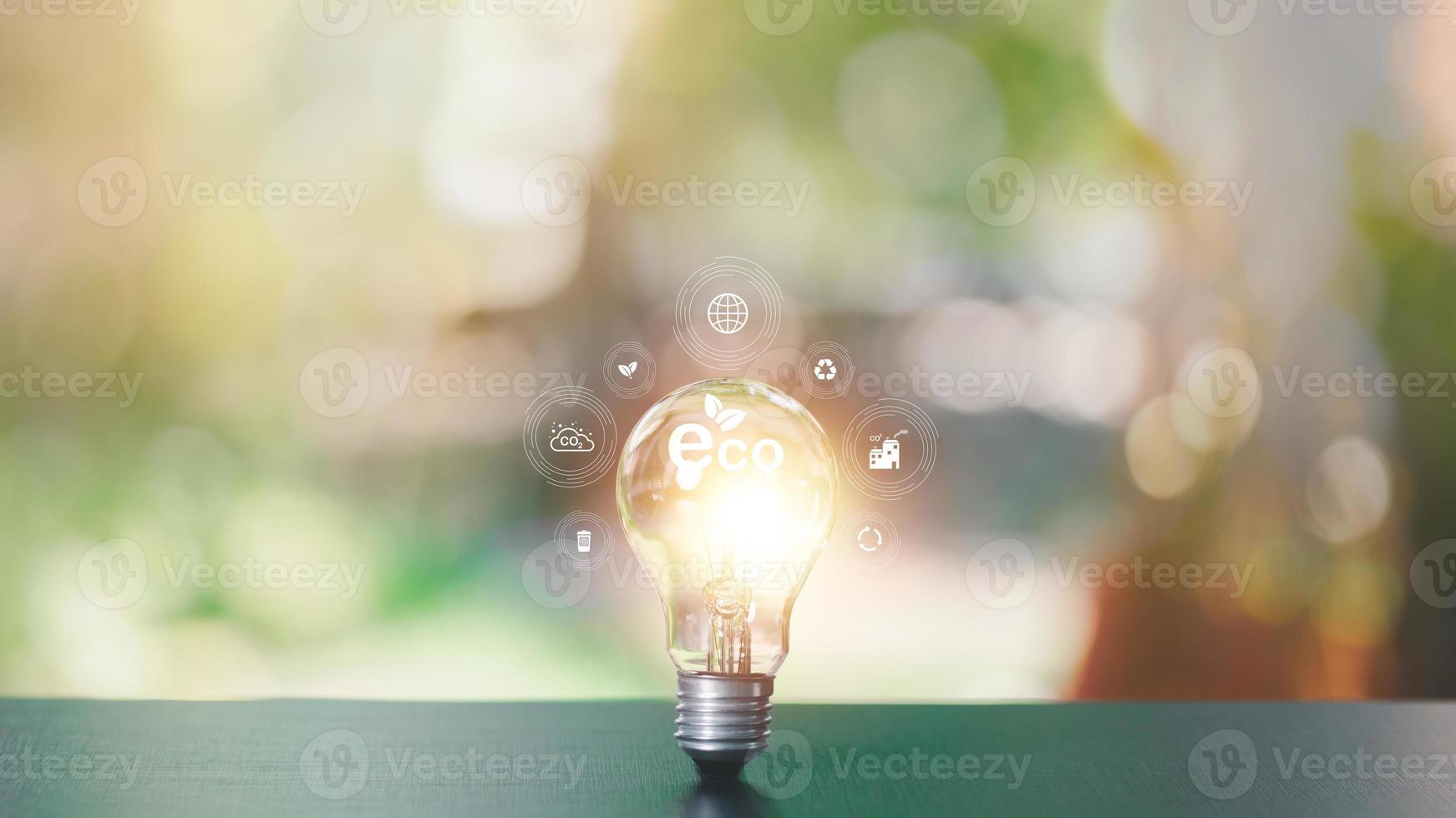 protecting the environment alternative energy Sustainable renewable energy sources Green energy innovation and environmentally friendly energy technology,Light bulb on table and nature background photo
