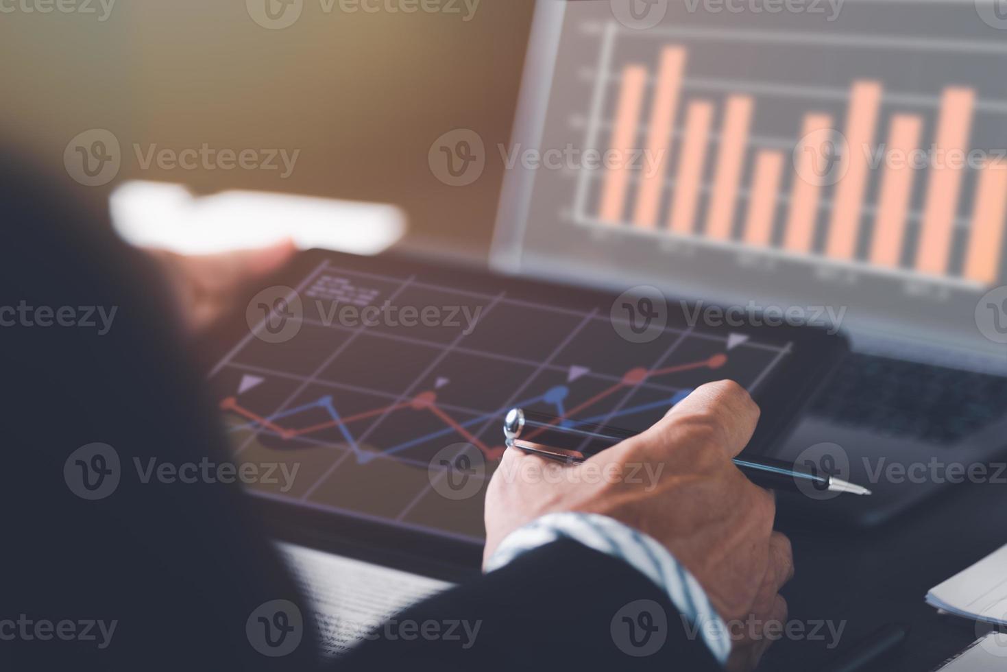 Businessman analyzing business growth graph,industry development achievements,effective investment trends,growth targets and increasing profits of organization,data gathering and statistical working. photo