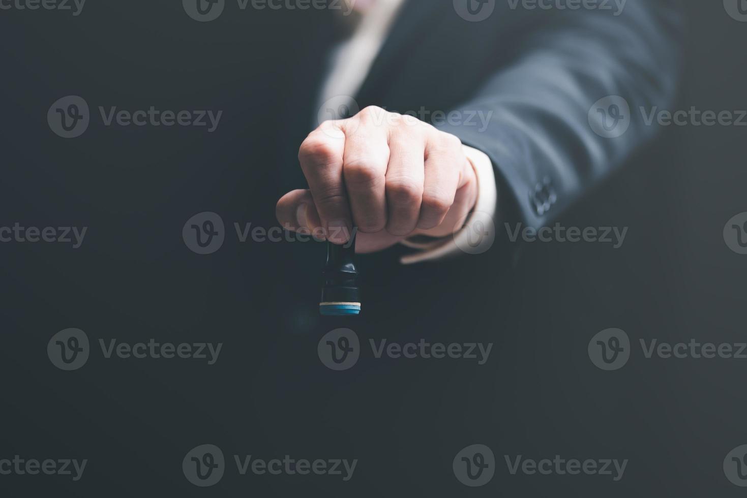 Businessman holding stamp in hand, concept of confirming or approving agreement. Authority to approve applications Bank loan documents through sponsorship, verification or acceptance process photo