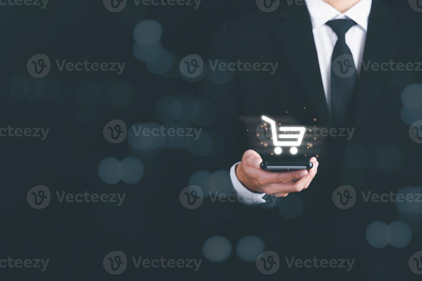 Operator holding a smartphone and showing a shopping cart icon,marketing strategy concept Customer Behavior and Purchase Analysis and customer research in various fields,online shopping, photo