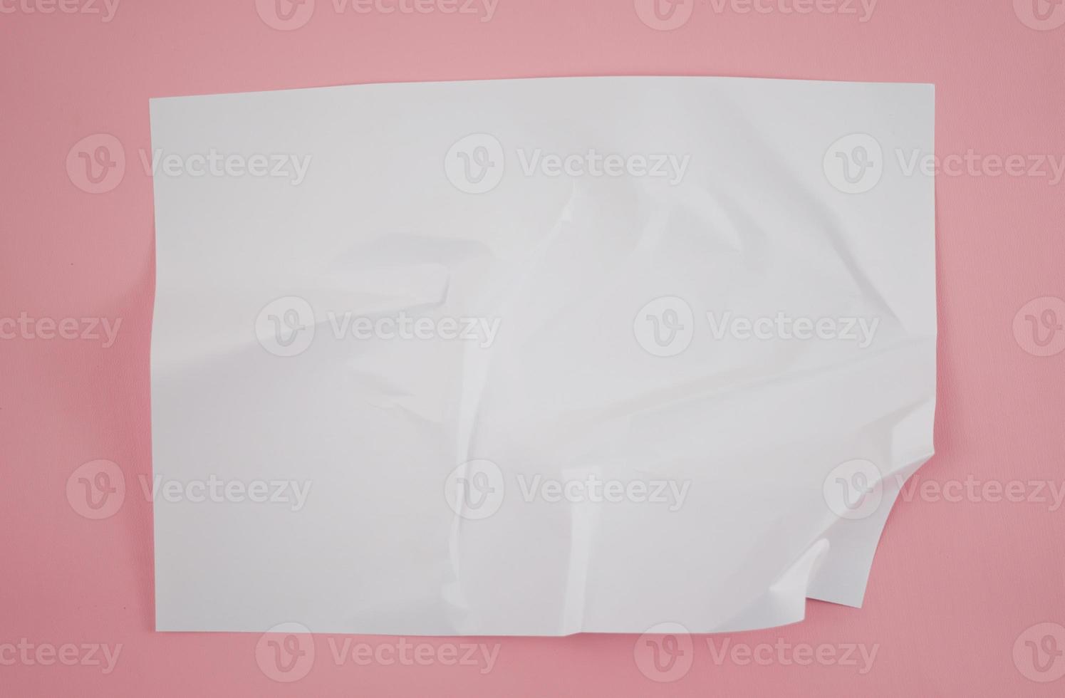 Abstract crumpled paper texture isolated in pink background photo