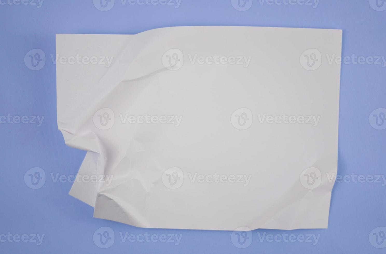 Abstract crumpled paper texture isolated in blue background photo