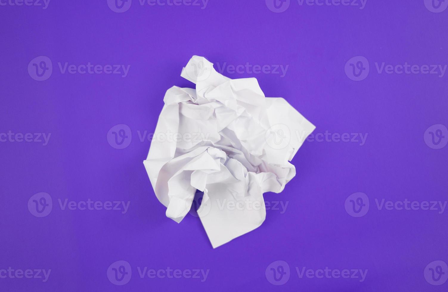 Abstract crumpled paper texture isolated in purple background photo