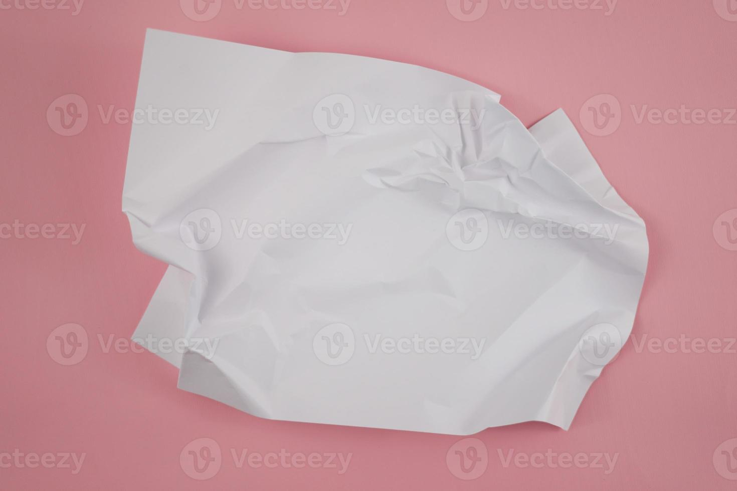 Abstract crumpled paper texture isolated in pink background photo