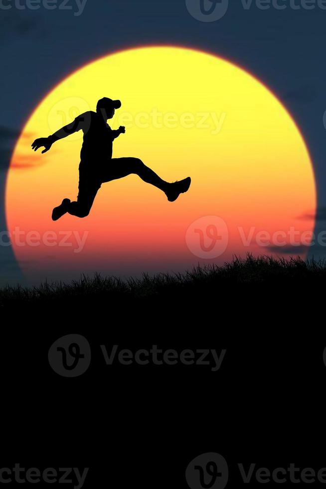 Vertical silhouette of a man jumping to the future. The concept of moving on to something better photo